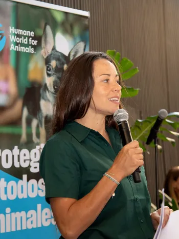 A woman in Chile talking into a microphone at an event