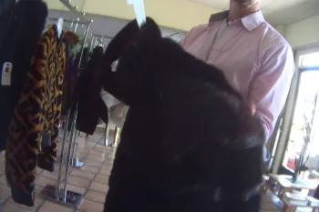 A person holds a fur coat