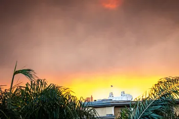 Smoke from the wildfire lights up the morning sunrise over downtown Los Angeles, CA.