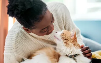 Woman cuddling with her cat