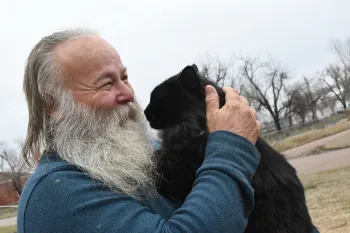 Smiling man holding a cat