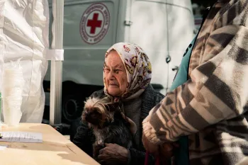 A woman receives aid for her dog