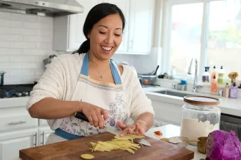 Joanne Molinaro, the Korean Vegan, chops ingredients for a recipe